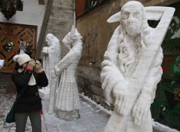 A girl takes pictures ice sculptures