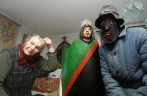 Young people in the suits of fairy-tales heroes sing carols