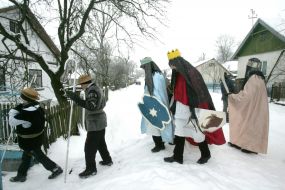 Young people in the suits of fairy-tales heroes are going to sing carols
