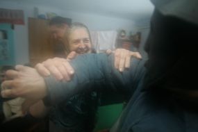 An old woman meets Christmas carolers