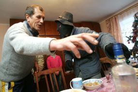 A man suggests to have a drink to Christmas caroler