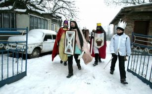 Young people in the suits of fairy-tales heroes are going to sing carols