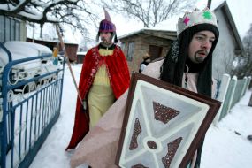 Young people in the suits of fairy-tales heroes are going to sing carols