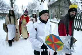Young people in the suits of fairy-tales heroes are going to sing carols