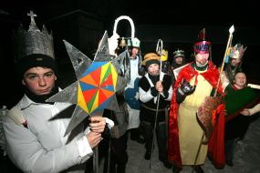 Young people in the suits of fairy-tales heroes are going to sing carols