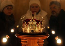 Visitors examine a crown
