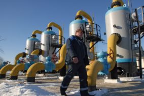 An operator passes near the equipment of the gas-measuring unit