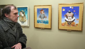 A visitor examines pictures