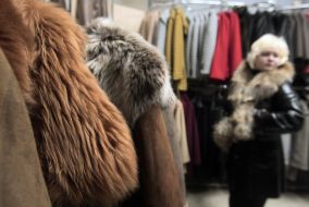 A woman chooses a fur coat