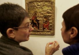 Visitors of exhibition «Christmas» examine an icon