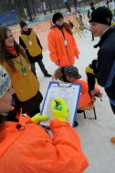 Judges prepare a skier to the race