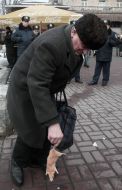 A passer-by holds a rat