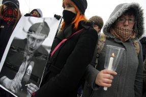 The action participants hold the picture of the lost advocate Stanislav Markelov