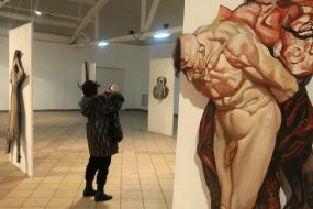 A visitor takea picture Sergey Yakutovich’s works