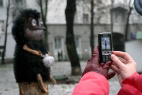 A girl takes picture ”Hedgehog in fog” monument