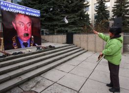 A woman gives up running shoes in a placard
