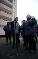 Women clean the territory before new building