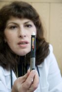 A doctor demonstrates syringe-pen