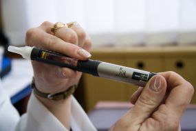 A nurse demonstrates syringe-pen