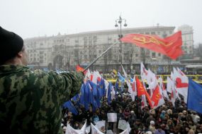 The participant of action of protest swings by a flag