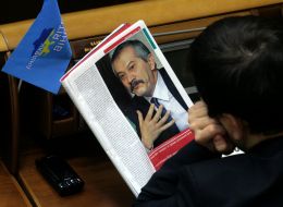 A folk deputy reads a magazine