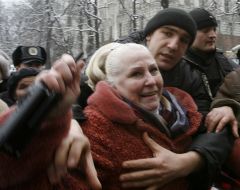”Berkut” special division fighter takes away a radio transmitter portable from the protest action participant