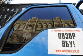 Placard with a slogan ”Disgrace of NBU”