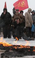 Communist party of Ukraine supporters burn a fascist flag with a swastika