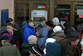 «Rodovid bank» depositors stand in a queue near ATM