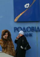 «Rodovid bank» depositors stand near ATM