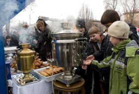 Boys stand near a samovar