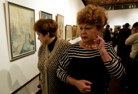 Visitors examine pictures