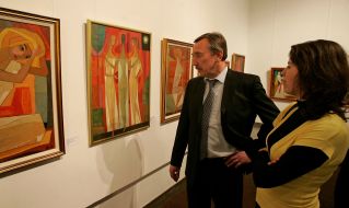 Visitors examine pictures