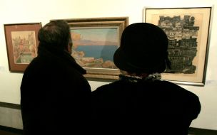 Visitors examine pictures