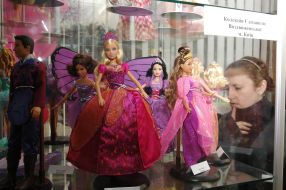 A woman examines of Barbie doll