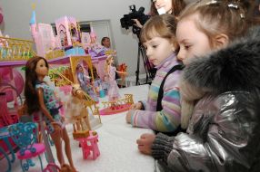 A girls examines of Barbie doll