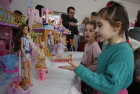 A girls examines of Barbie doll
