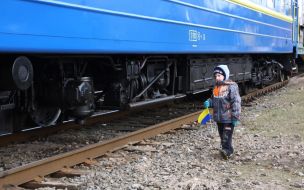 A boy passes near a train