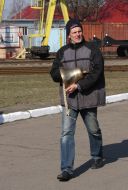 A worker carries a bell