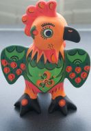 A cock sits on a sycamore and hang his bloody wings