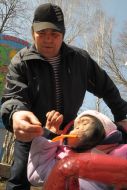 The zoo worker feeds a chimpanzee