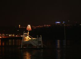 An artiste swims on a bed on water