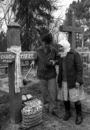 Local habitants measure the level of radiation on a cemetery