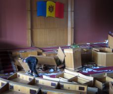 Policeman examines the Moldavia parliament sessions raided hall