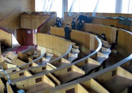 Policemen examine the Moldavia parliament sessions raided hall