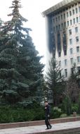A policeman passes near burning Moldavia parliament building
