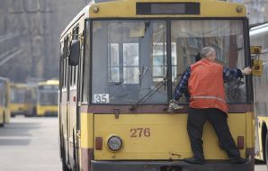 The driver of trolleybus washes glasses