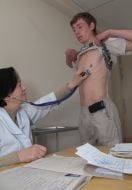 A doctor examines a draftee