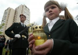 A girl palms on the hands light candle