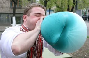 The participant of holiday inflates a hot-water bottle